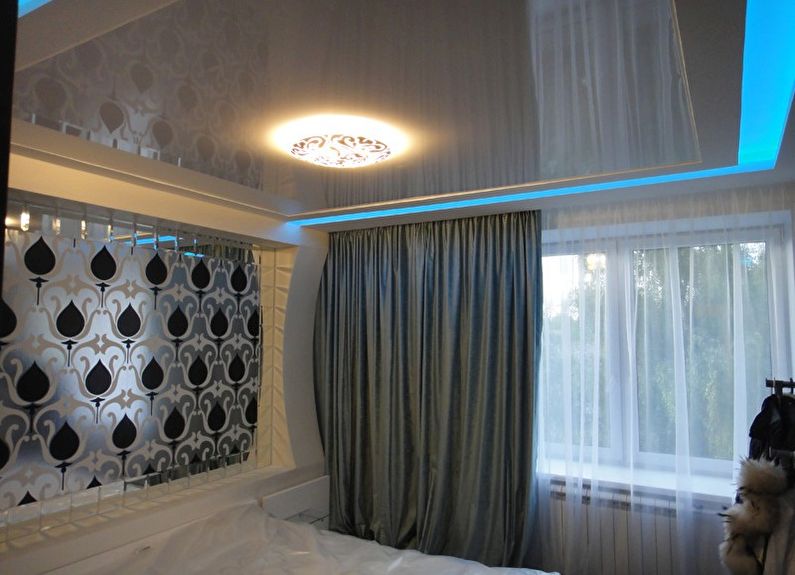 White glossy stretch ceiling in the bedroom - photo