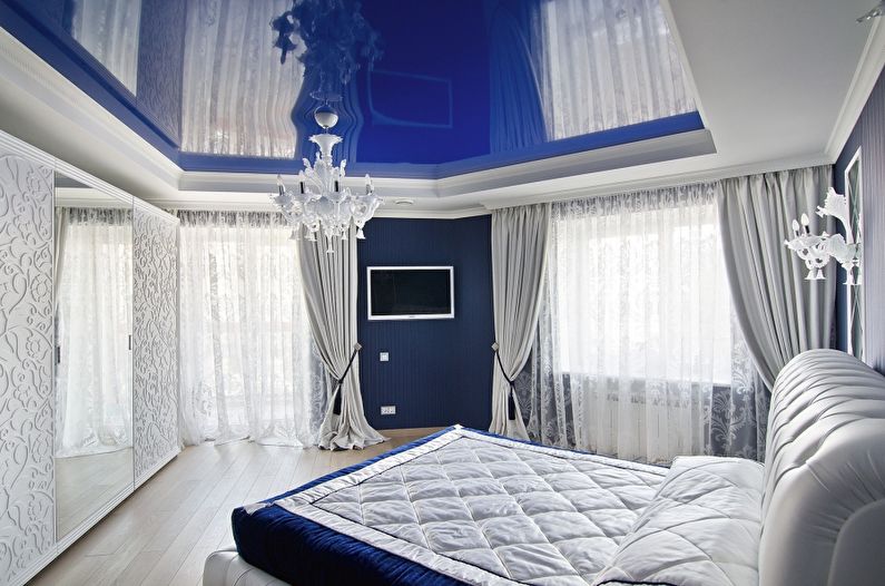 Blue glossy stretch ceiling in the bedroom - photo