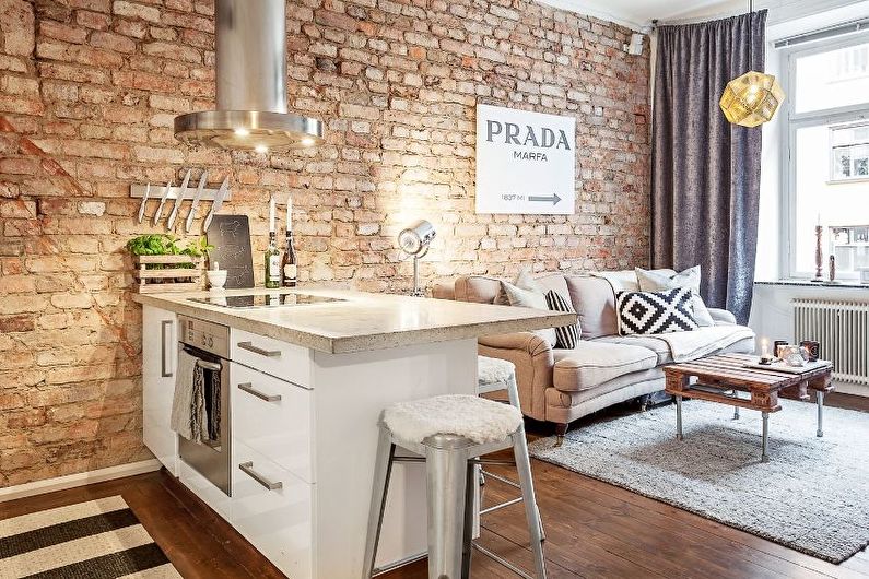 Interior design of a kitchen-living room in the loft style - photo