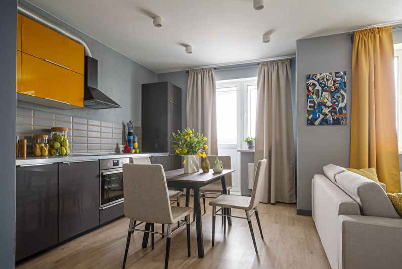 Interior design of a kitchen-living room in gray - photo