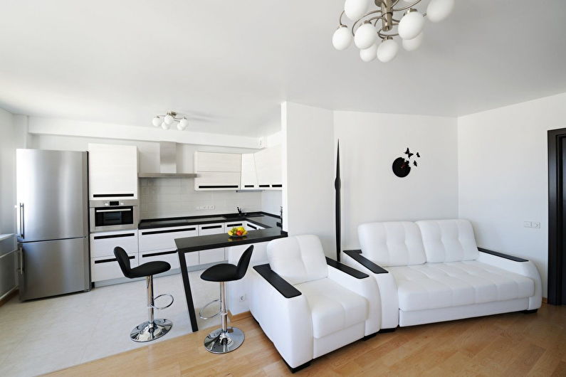 Interior design of a white kitchen-living room - photo