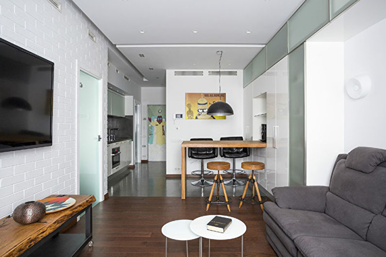 Interior design of a kitchen-living room in white - photo