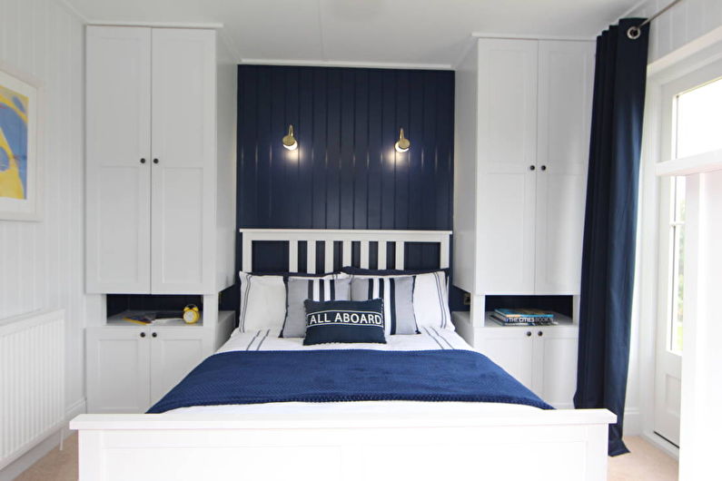 Design of a small bedroom in blue tones - photo