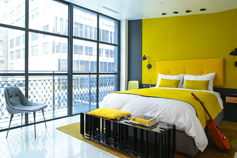Design of a small bedroom in yellow tones - photo